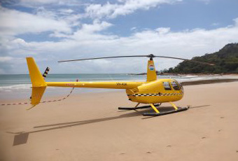 Yellow helicopter on the beach.
