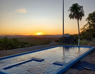 Swimming pool with a sunset backdrop.